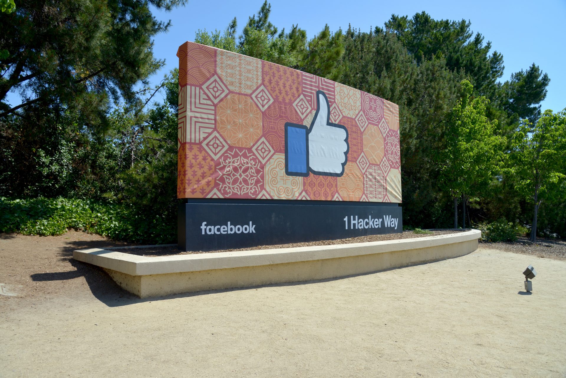 Facebook like button a small bulleton board with a bench beneath it