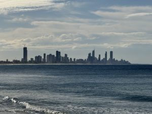 A city in the distance with skyscrapers separated by a calm body of water.