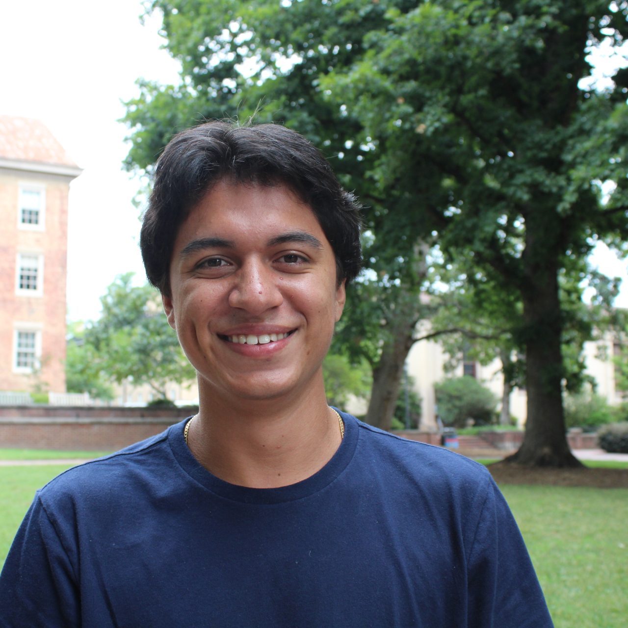 Agustin Orozco smiling with a UNC quad in the background